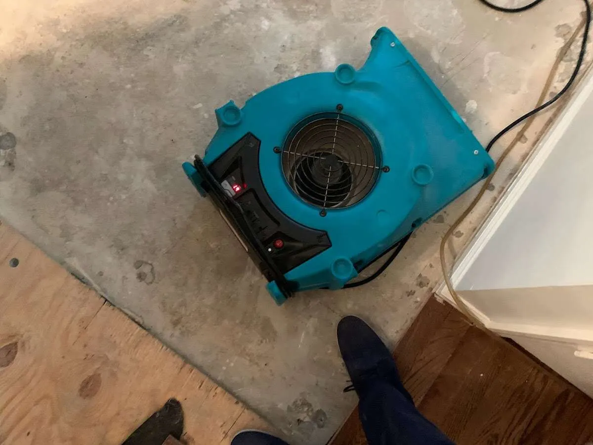 Air mover drying subfloor during Commercial Water Damage Restoration in North Laurel